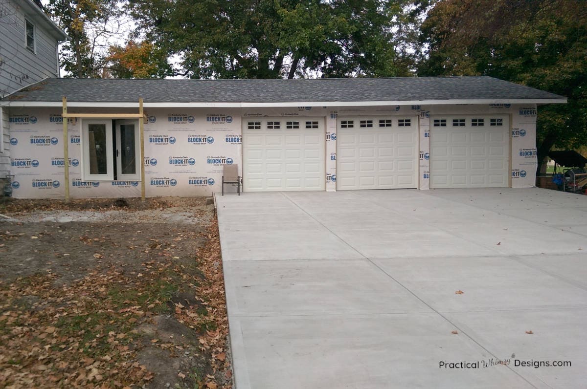 Three car garage with new concrete driveway