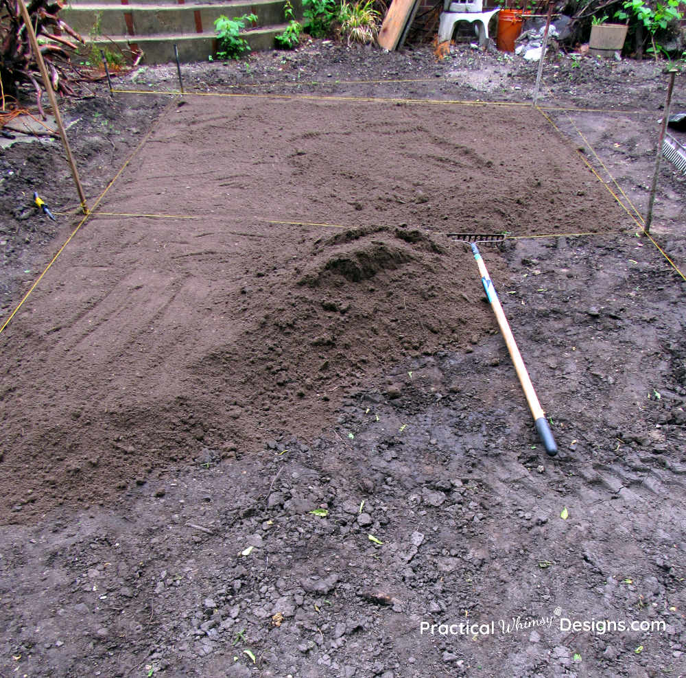 Spreading topsoil for new grass seed