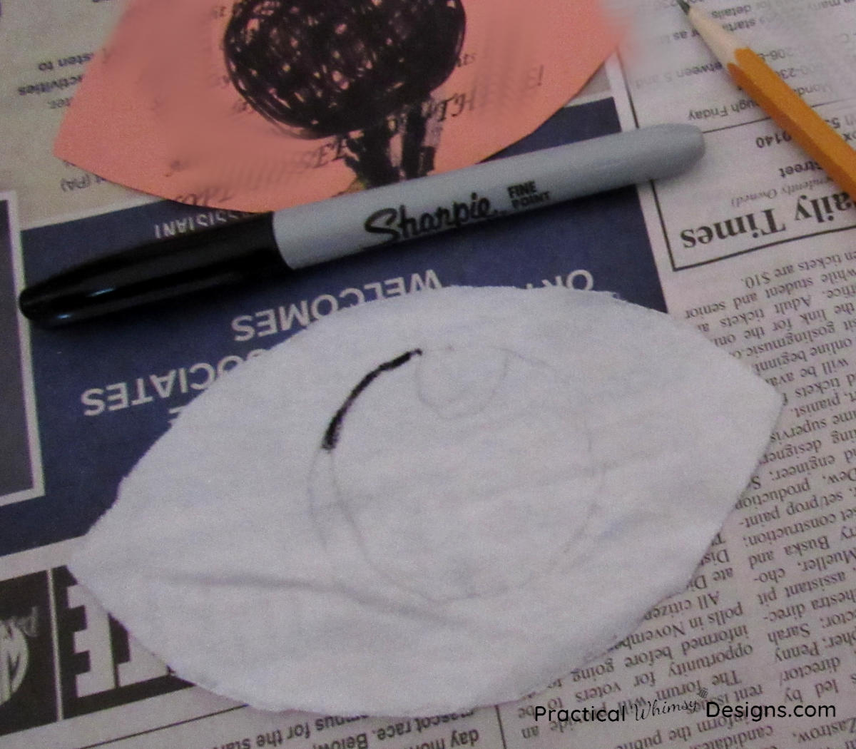 drawing pupil on fabric eye with sharpie for flying purple people eater costume