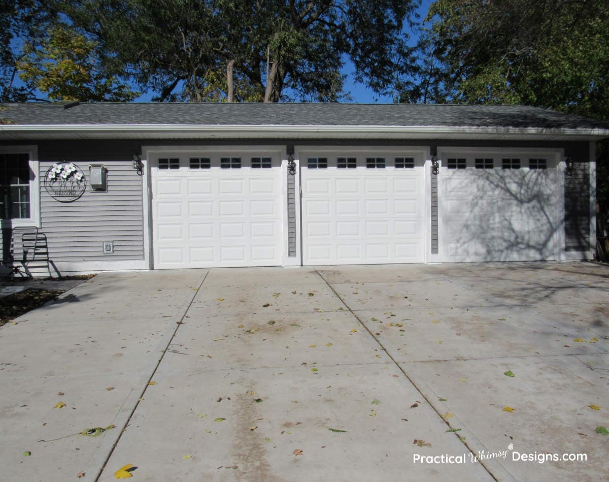 Three car garage with white garage doors