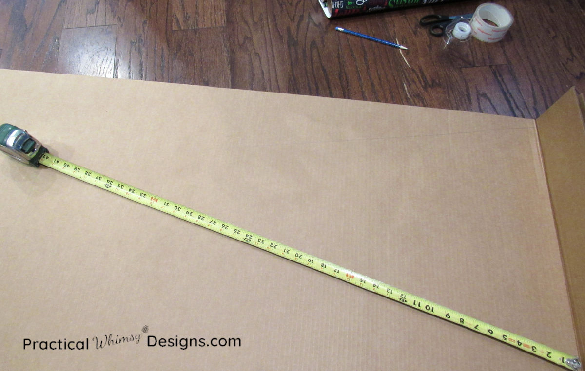 Using a tape measure to measure an angle on cardboard