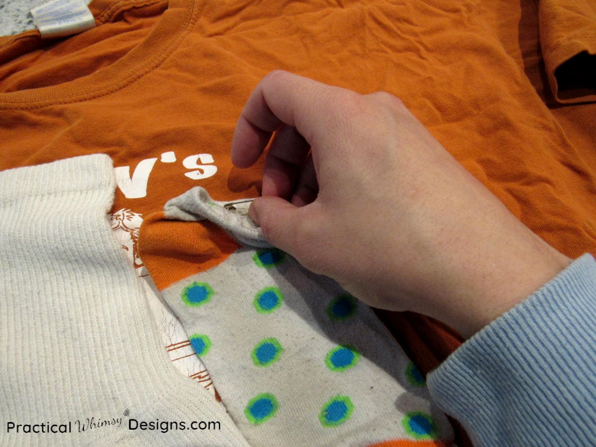 Safety pinning socks on t-shirt