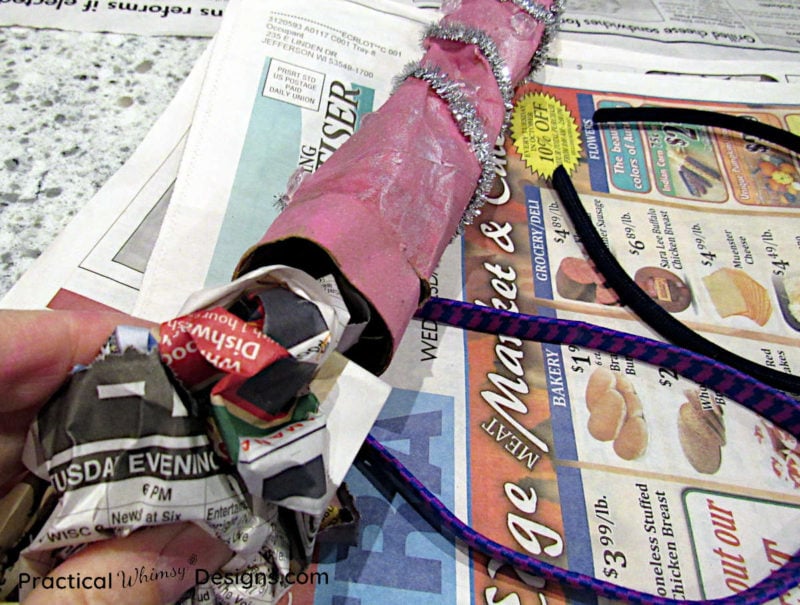Stuffing newspaper into bottom of unicorn horn craft