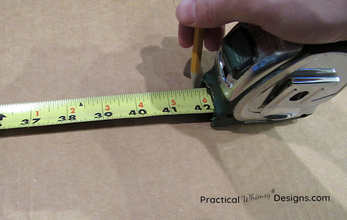 Using a tape measure to mark on cardboard