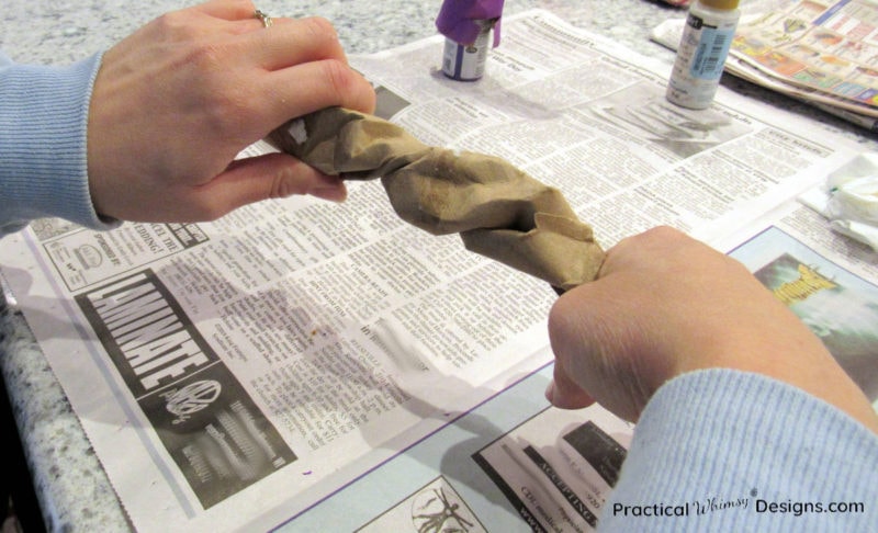 Twisting paper towel roll to make a unicorn horn craft