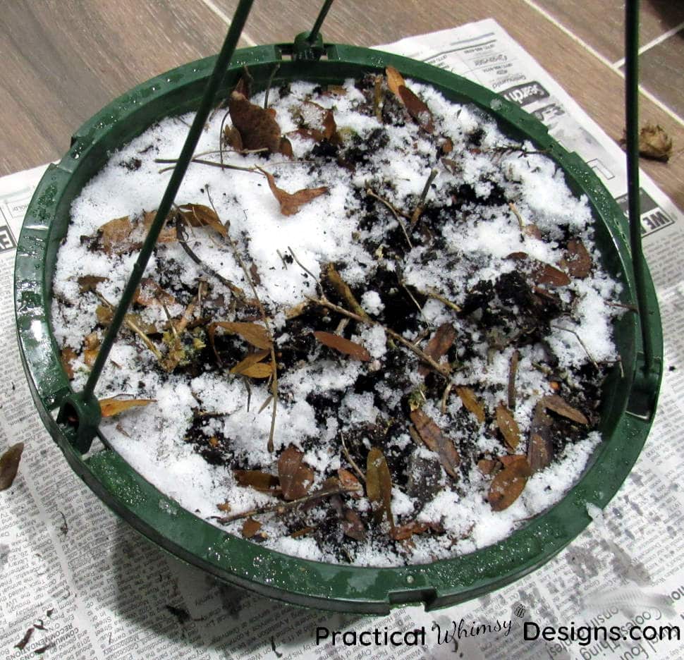 Hanging basket full of snowy dirt