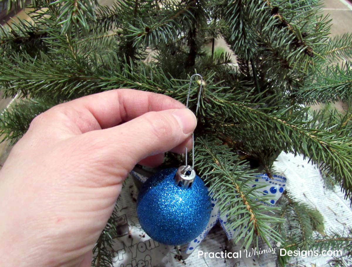 Hanging ornaments on pine boughs in basket