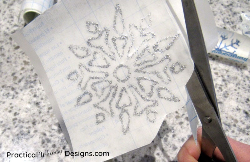 Cutting out snowflake window decal