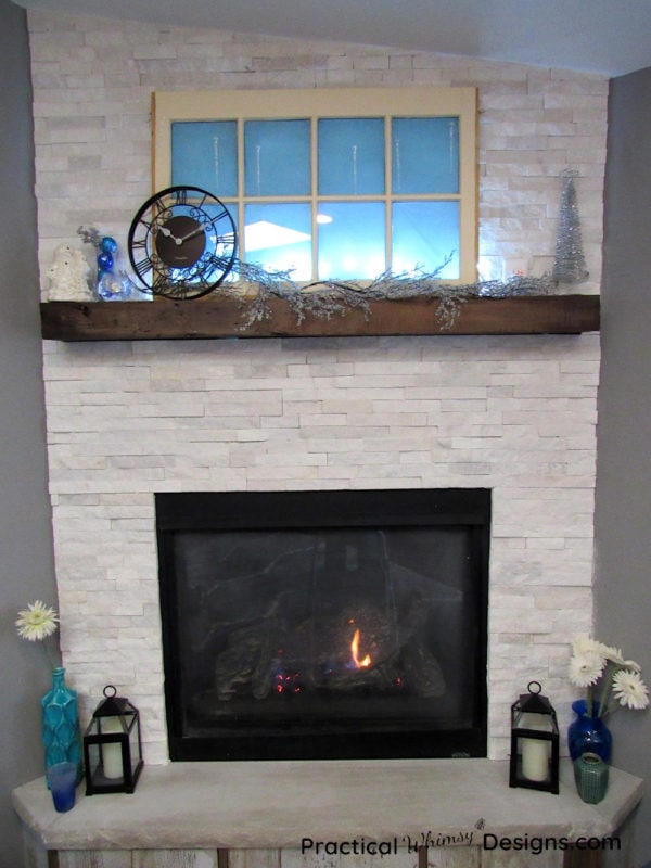 Flowers and winter decorations by fireplace