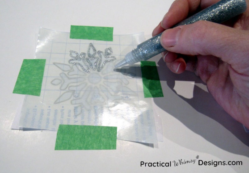 glitter glue snowflake on contact paper