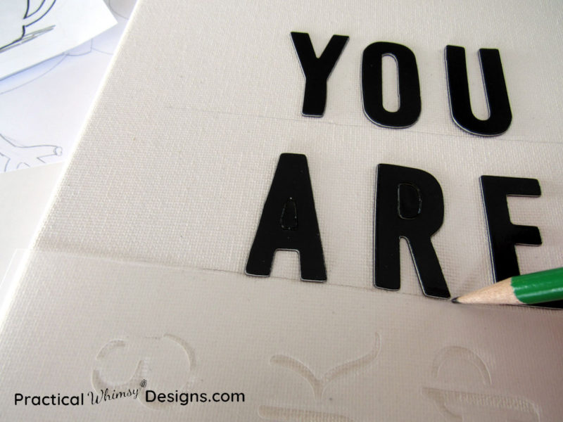 Pencil tracing lettering onto canvas pictures