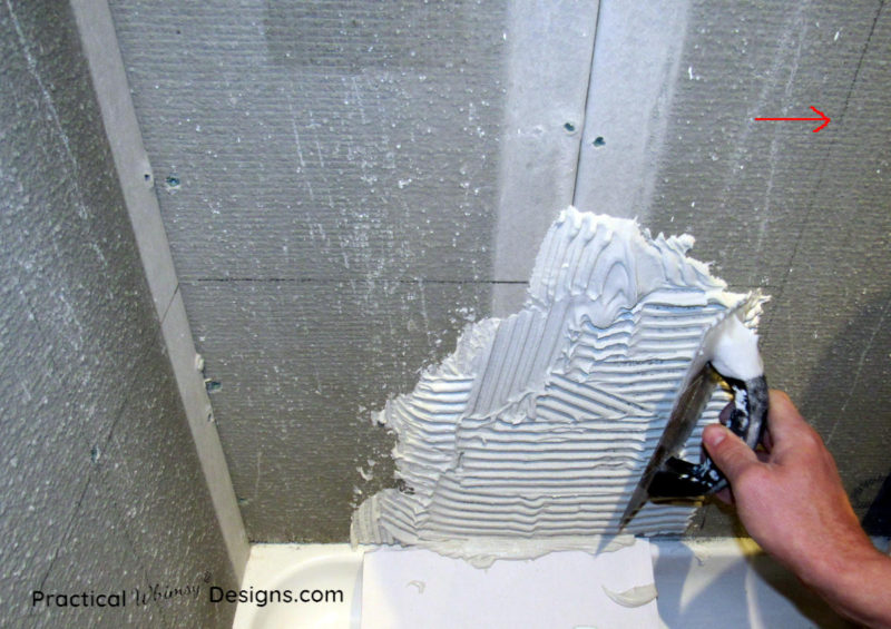 Applying mortar to wall for tiling