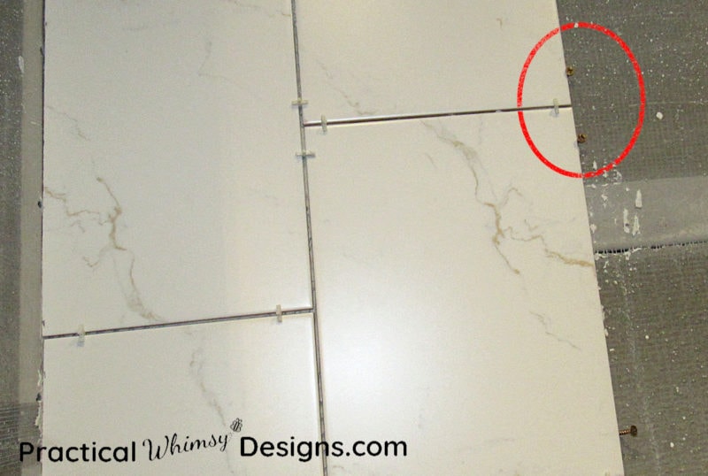 How to tile using screws along tile to hold it in place 