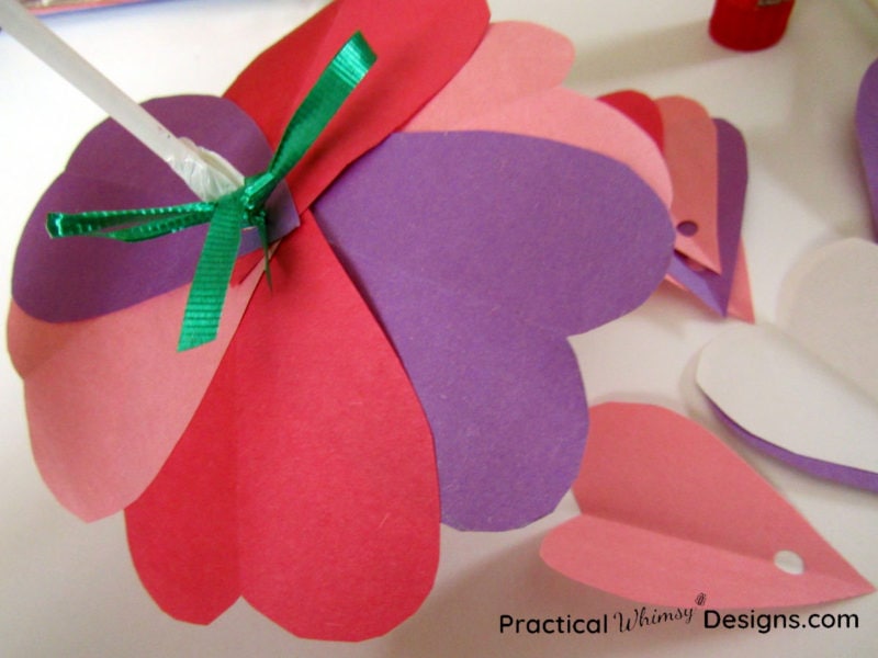 Tying ribbons on valentines card flowers