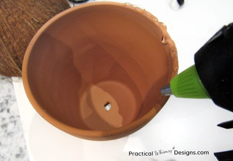 Hot gluing rim of clay pot