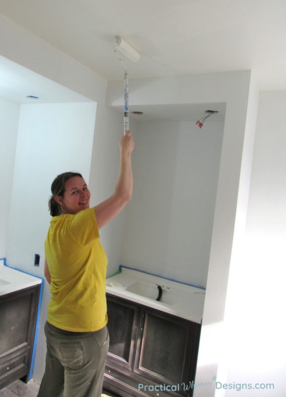 Rolling paint on the ceiling in the master bathroom