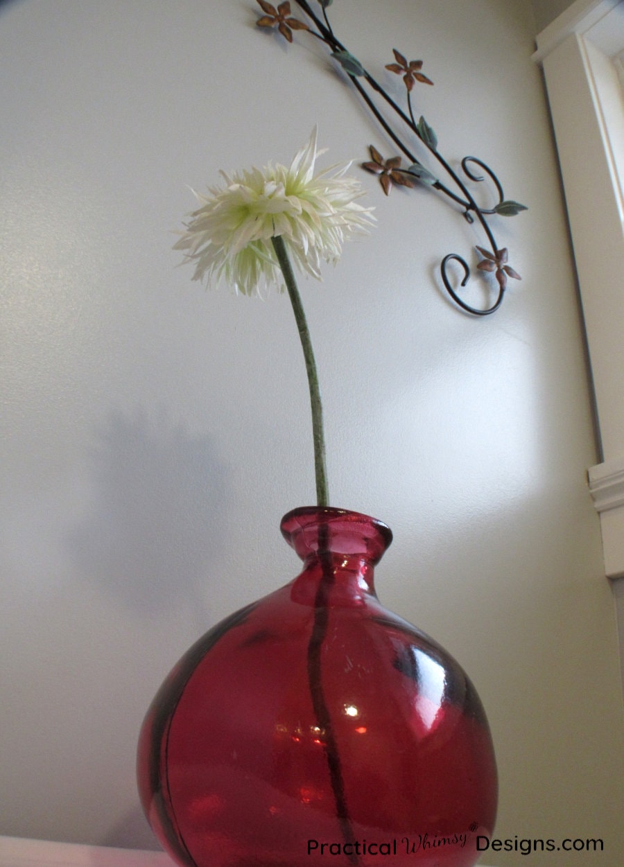 Red vase and white flower