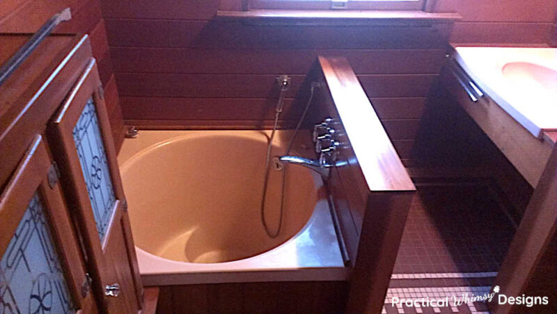 Pink Japanese soaking tub in dated bathroom