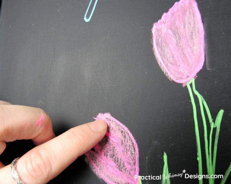 blending chalk with finger as a technique on how to stencil chalkboards