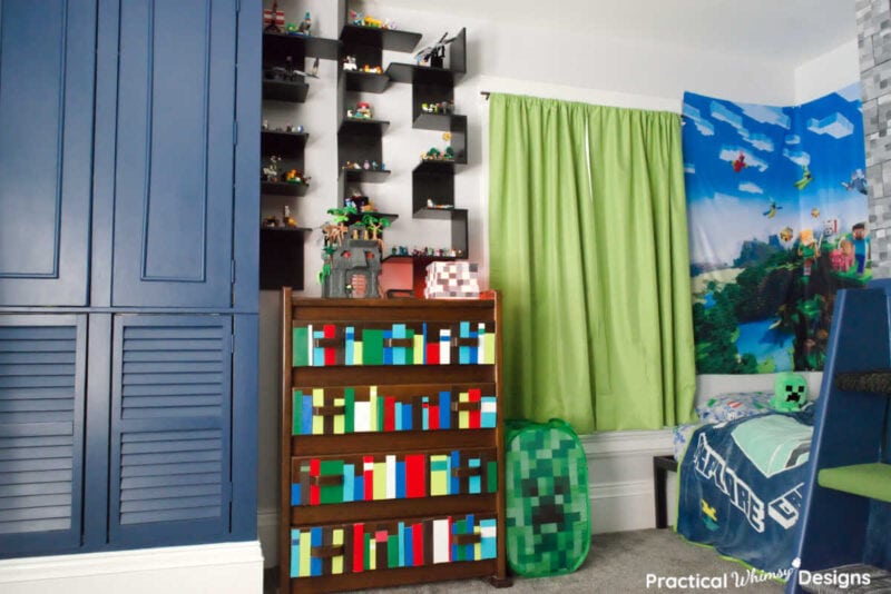 Built in cabinet, faux book shelf dresser and, minecraft themed decor in boys' video game bedroom design