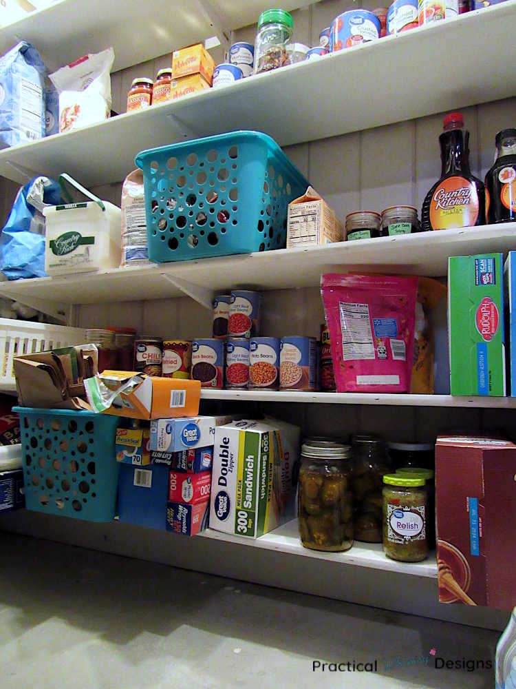 Pantry shelf with groceries and extra boxes of bags on it.