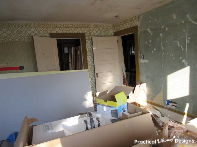 Boys bedroom before remodel with some wall paper removed