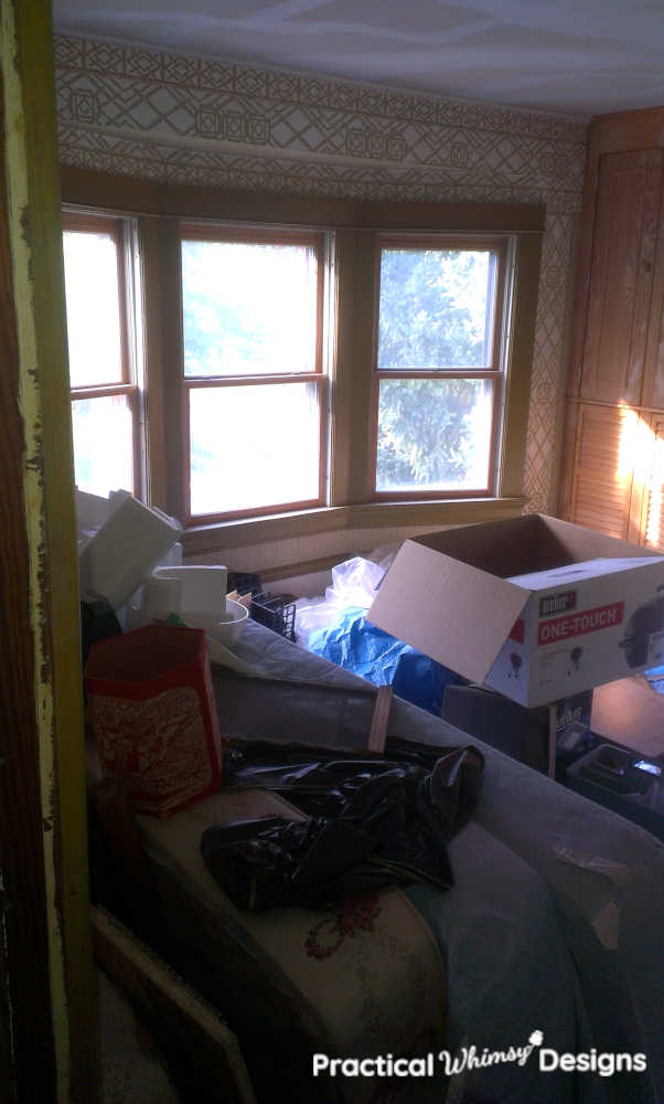 Bedroom piled with old mattresses and clutter 