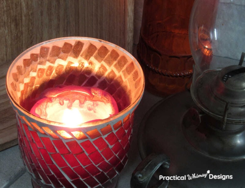 Lit orange and red candle for neutral fall decor ideas