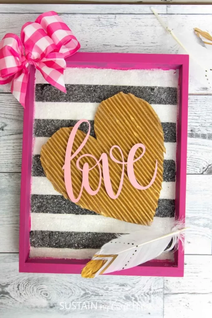 Corrugated cardboard heart on striped background as a Paper Craft art piece for Valentines Day.