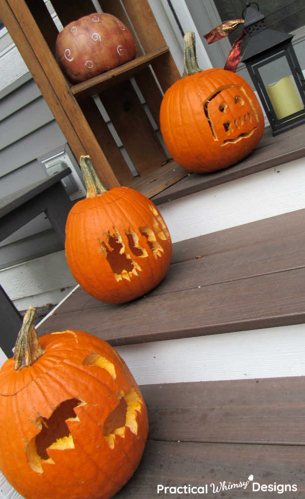 Carved pumpkins on porch steps