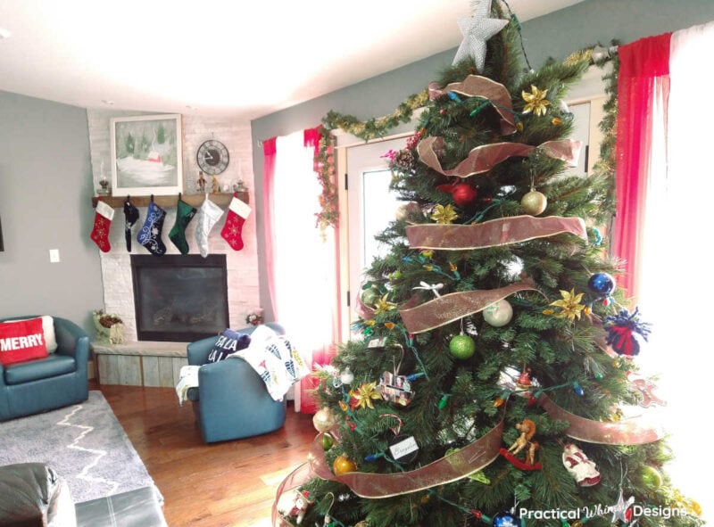 Family room decorated for Christmas with tree and stockings on mantel