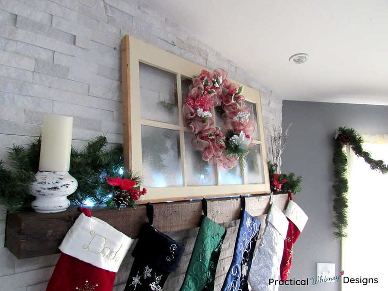Birch candlestick, window, wreath, and greenery on Christmas mantel.
