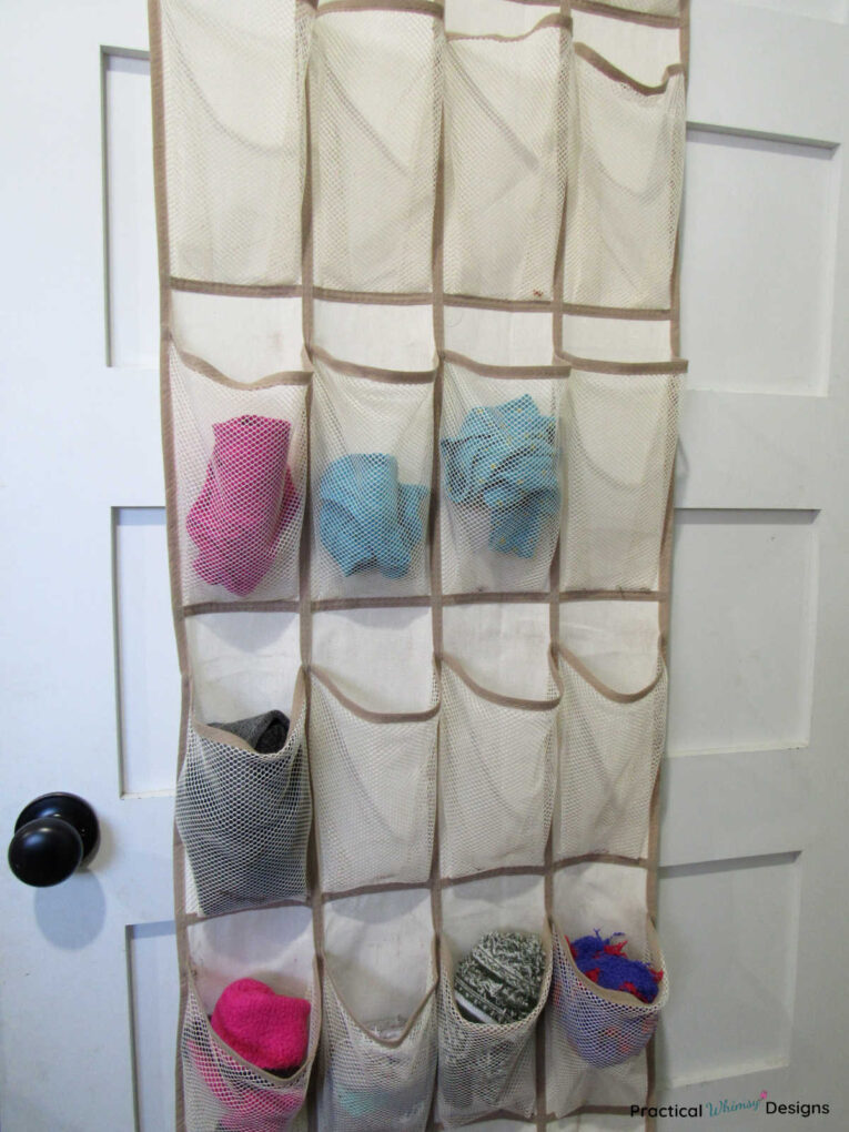 Closet door organizer with underwear and socks stored in mesh pockets.