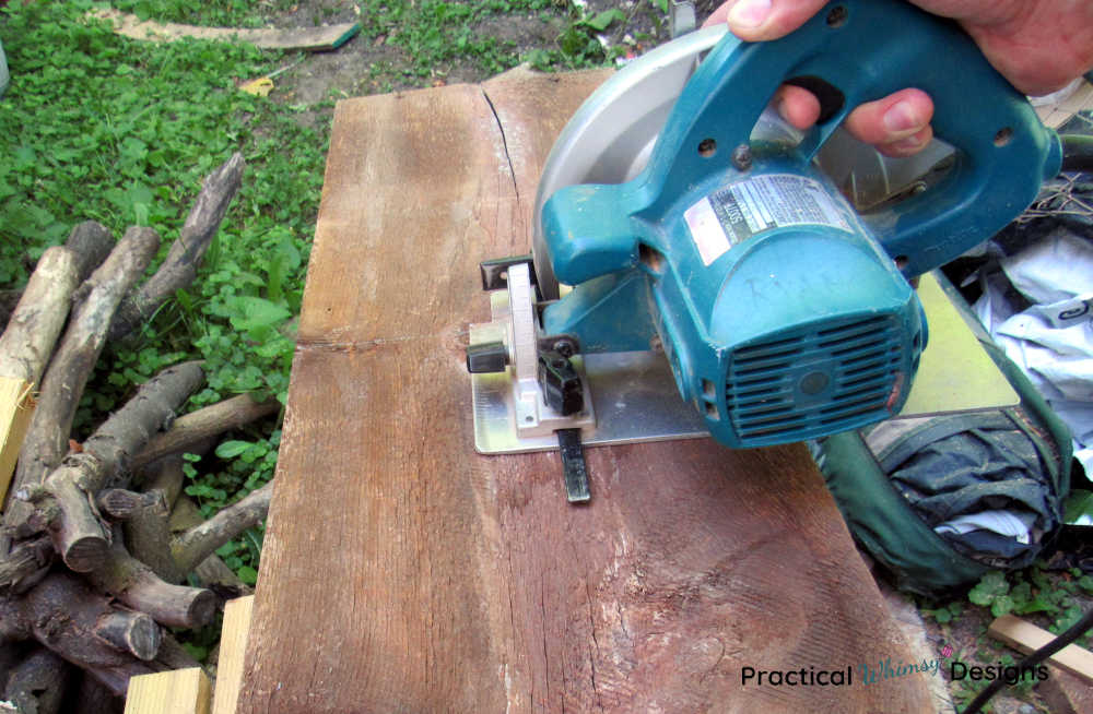 Cutting two foot boards with a circular saw.