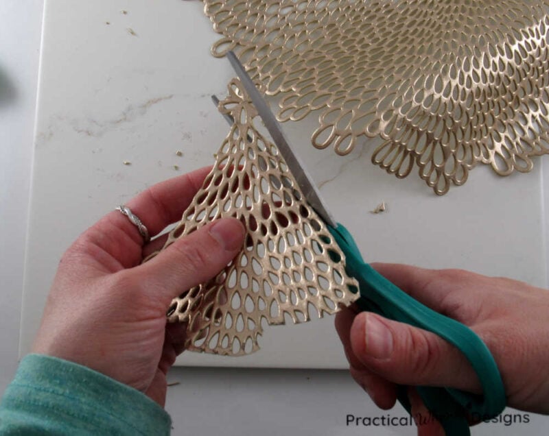 Trimming the edges of the placemat with scissors to create a better tree shape.