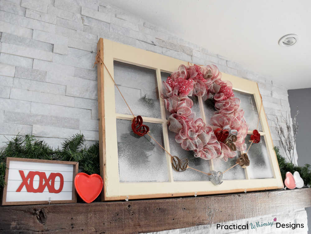 DIY mesh Valentine's wreath and heart decor with window on mantel.