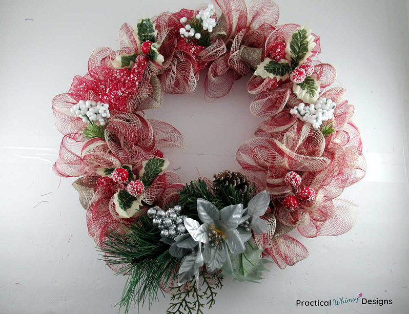 Red and brown DIY mesh Christmas wreath with flowers and berries.