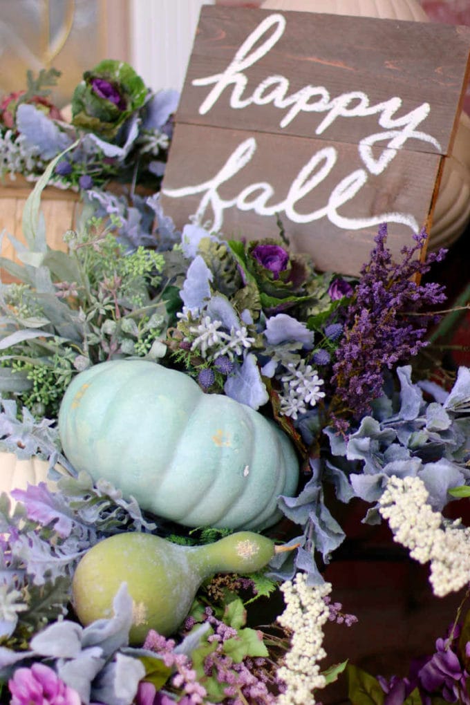 Happy fall sign with flowers and pumpkins