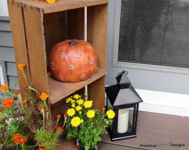 Fall decor and flowers on small porch