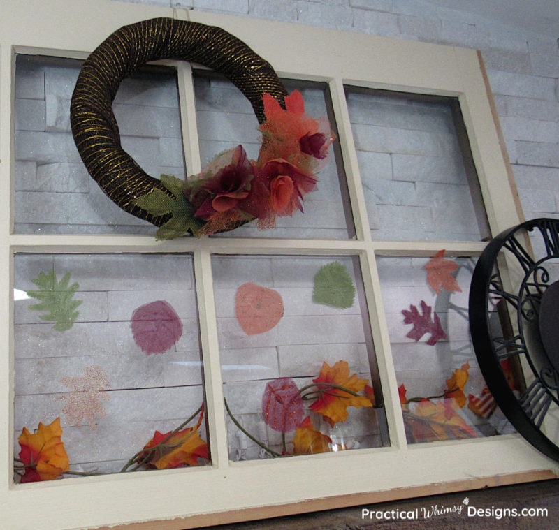 Fall wreath and leaves on window