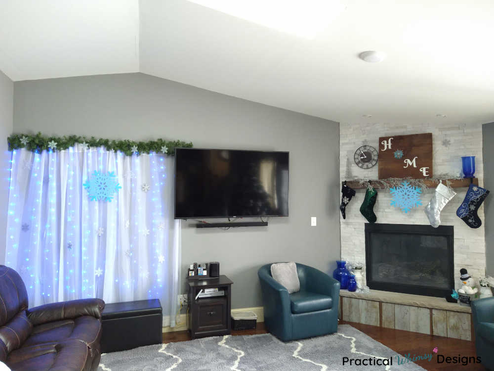 Snowflake lighted curtain hanging in family room.