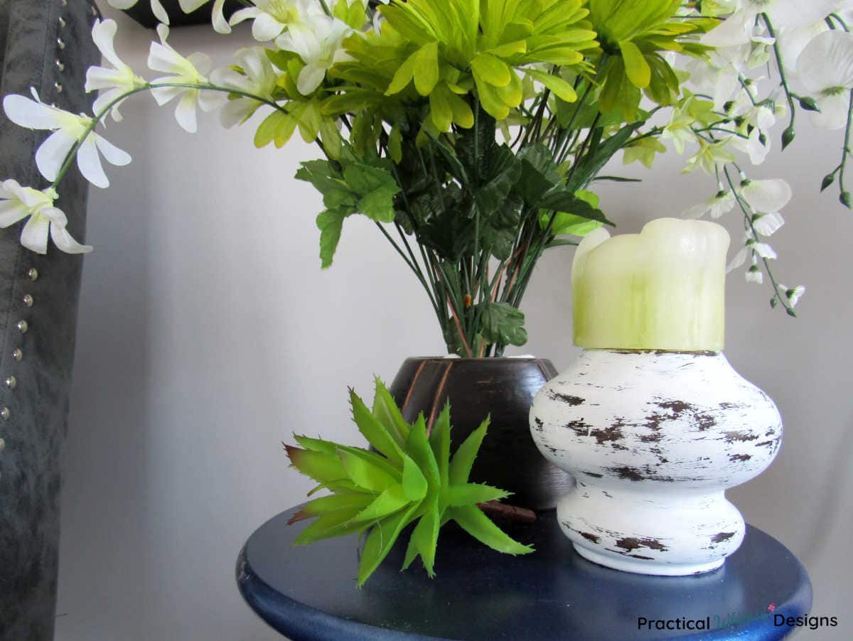 Upcycled Farmhouse candlestick with vase of white and green flowers