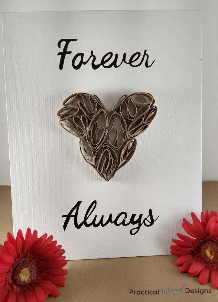 Forever Always 3D heart art on canvas with red flowers next to it.