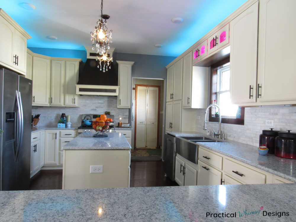 Full kitchen reveal with white cabinets and quartz counters