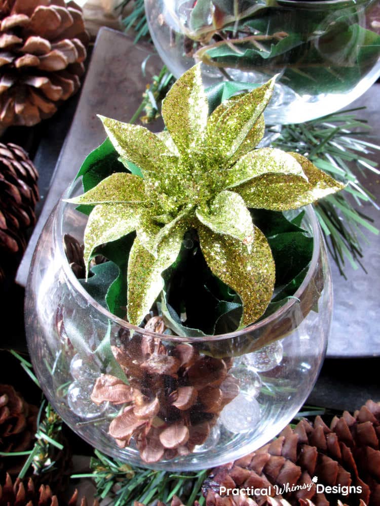 Wine glass filled with gold flower and pinecones