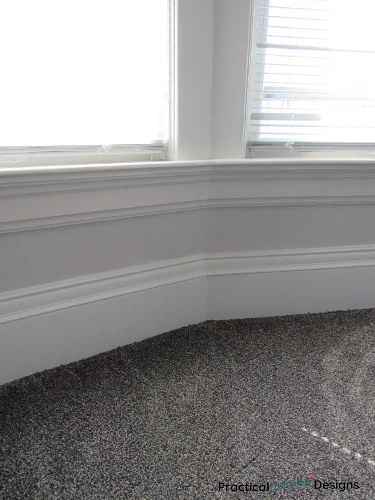 Grey carpet next to windows