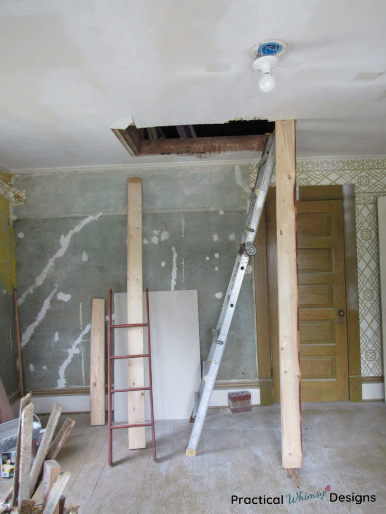 Hole in bedroom ceiling with ladder leaning against it.