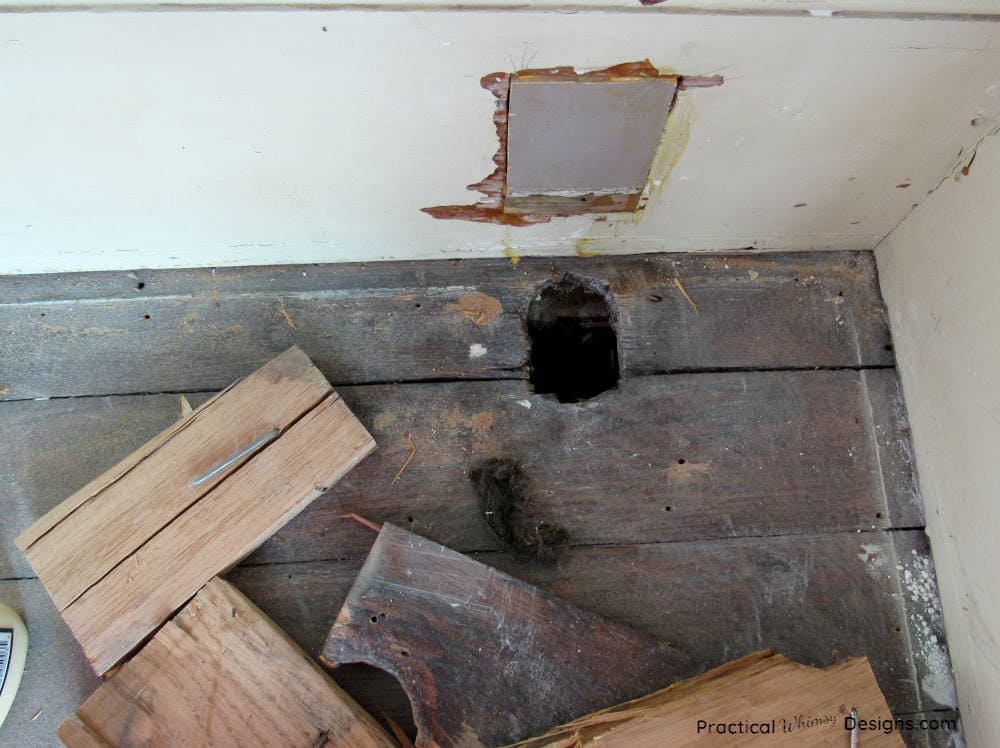 Hole in wooden floor boards in master bedroom.