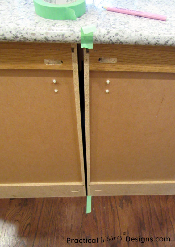 Marking cabinet seam with tape