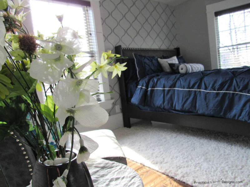 Master bedroom reveal with navy bed and gray stenciled wall